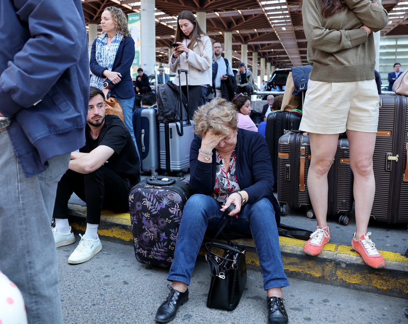 People waiting outside a train station during a power outage.