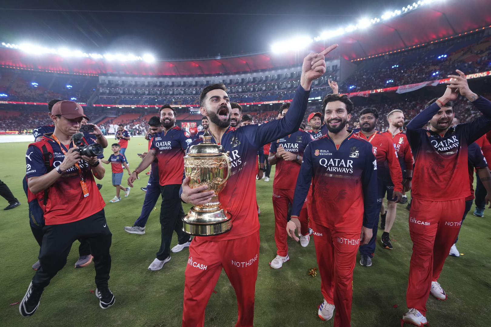 Virat Kohli celebrates with the trophy